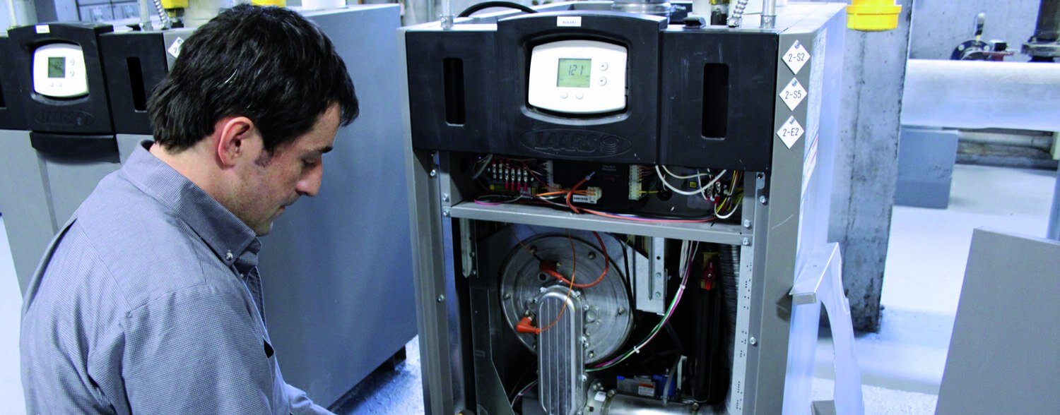 Repairman in front of a water heater unit