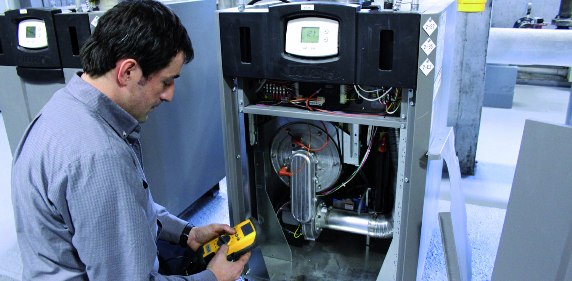 technician doing the maintenance of a commercial heater